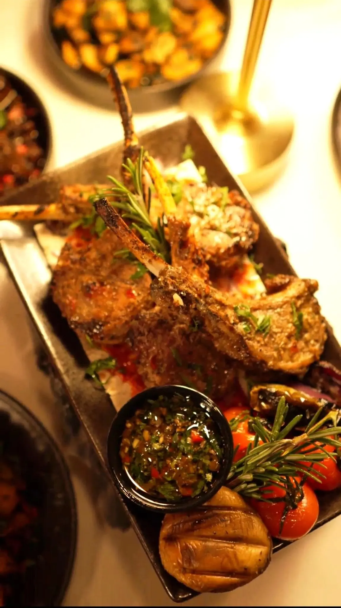 Rosemary-crusted lamb chops plated with garnish at Dunya Lounge