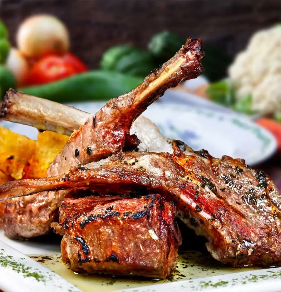 Seared lamb chops with char marks served at Dunya Lounge