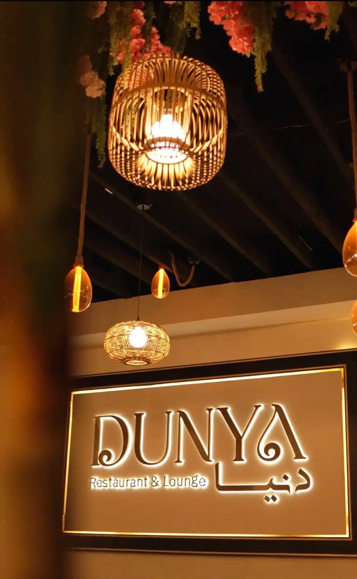 Close-up detail of the floral decor and lighting at Dunya Lounge