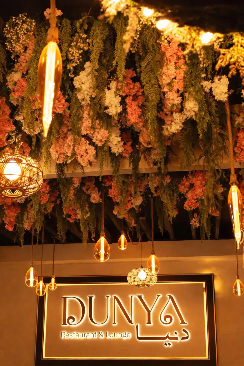 Dunya Lounge floral ceiling installation with lush greenery and soft lighting