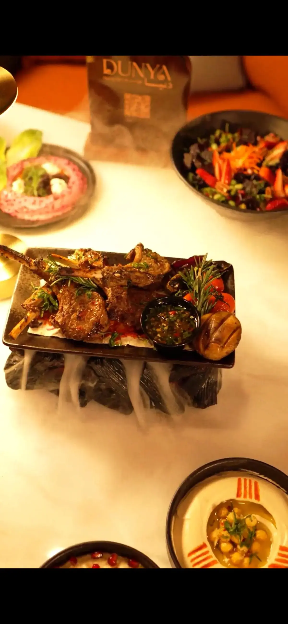 Theatrical sizzling platter presentation with dry ice at Dunya Lounge